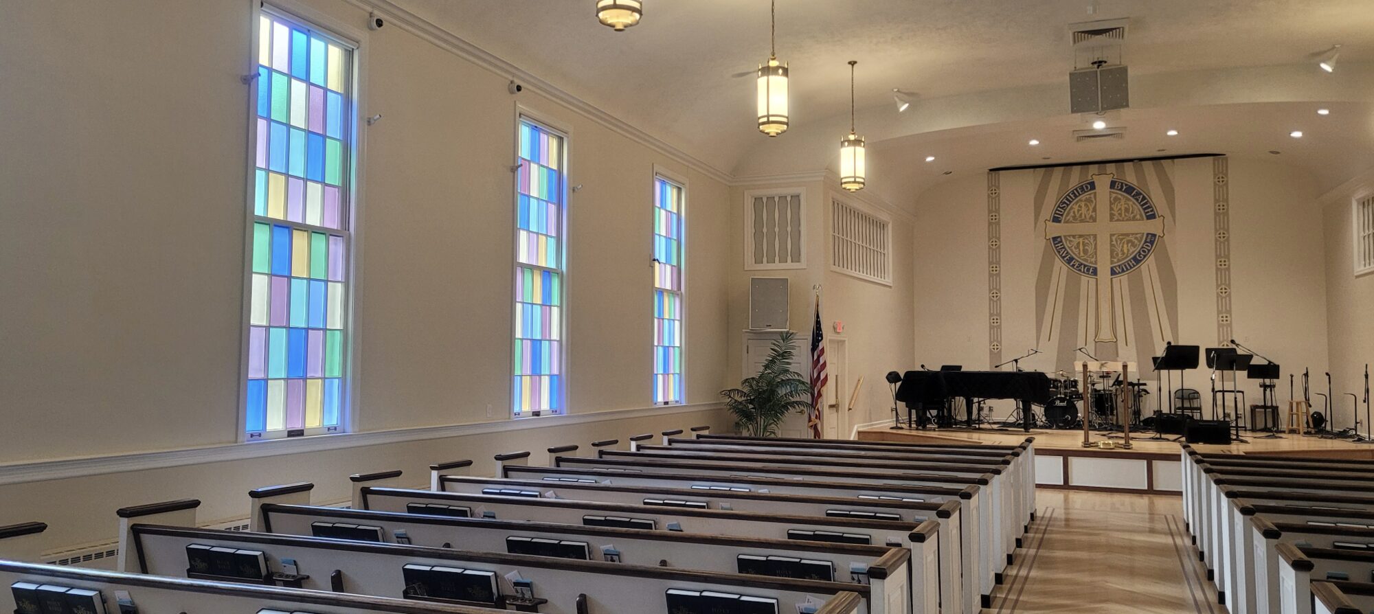 Stained glass and pews inside Calvary's sanctuary